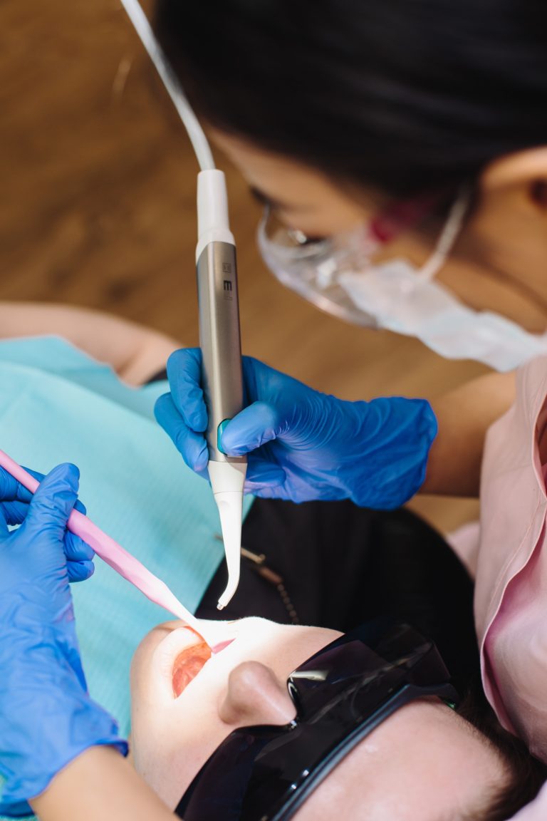 A dentist examining a patient's mouth.